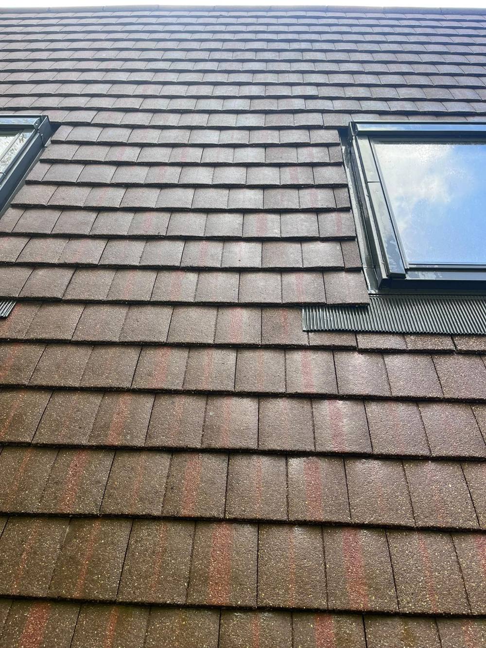 The same roof after cleaning, with the moss removed and the tiles left in place